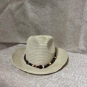 Tan straw hat with wire rim. One-of-a-kind wood and semi-precious stones band.